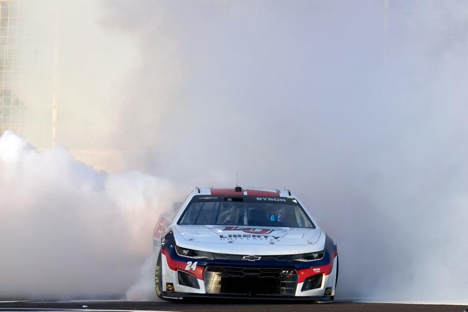 William Byron (24) does a burnout to celebrate after winning a NASCAR Cup Series auto race at Atlanta Motor Speedway in Hampton, Ga., Sunday, March 20, 2022. (AP Photo/John Bazemore)