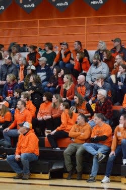 Harbor Springs and St. Ignace fans wear orange and black, Escanaba's colors, to show support for the Weaver family during a basketball game on Jan. 30.