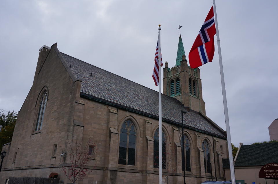 A U.S. and Norwegian flag stand outside of Den Norske Lutherske Mindekirke, the Norwegian Lutheran Memorial Church, a congregation in Minneapolis that's been worshipping in Norwegian every Sunday since its founding in 1922, Sunday, Oct. 16, 2022. (AP Photo/Giovanna Dell'Orto)