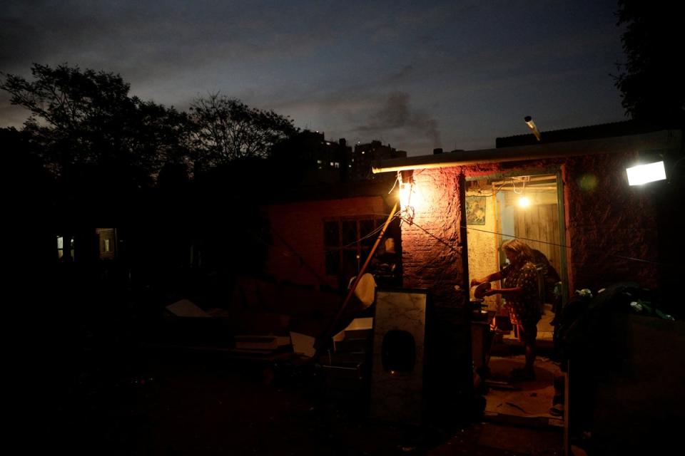 Elvira de Fatima Saraiva, 57, prepares dinner, the family's only meal of the day, in Porto Alegre (Reuters)