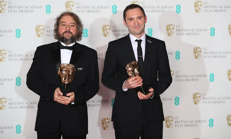 Jonathan Amos and Paul Machliss hold their awards for Editing for work on the film 'Baby Driver' at the British Academy of Film and Television Awards (BAFTA) at the Royal Albert Hall in London, Britain February 18, 2018. REUTERS/Hannah McKay