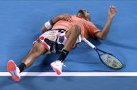 Australia's Nick Kyrgios lies on the court after his attempt to return a shot to Spain's Rafael Nadal during their fourth round singles match at the Australian Open tennis championship in Melbourne, Australia, Monday, Jan. 27, 2020. (AP Photo/Andy Wong)