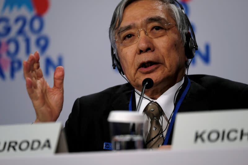 FILE PHOTO: Bank of Japan Governor Haruhiko Kuroda takes questions from reporters at the annual meetings of the International Monetary Fund and World Bank in Washington