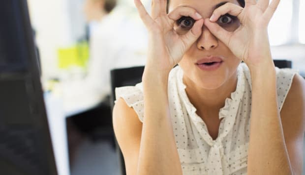 Businesswoman making a face at desk in office