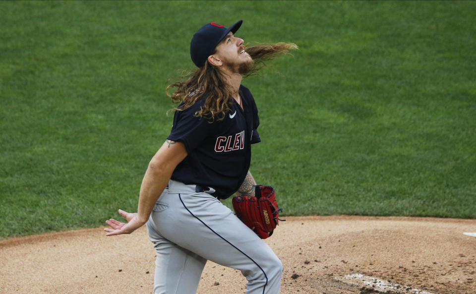 Cleveland Indians' pitcher Mike Clevinger watches the flight of a home run ball off the bat of Minnesota Twins' Eddie Rosario in the first inning of a baseball game Friday, July 31, 2020, in Minneapolis. (AP Photo/Jim Mone)