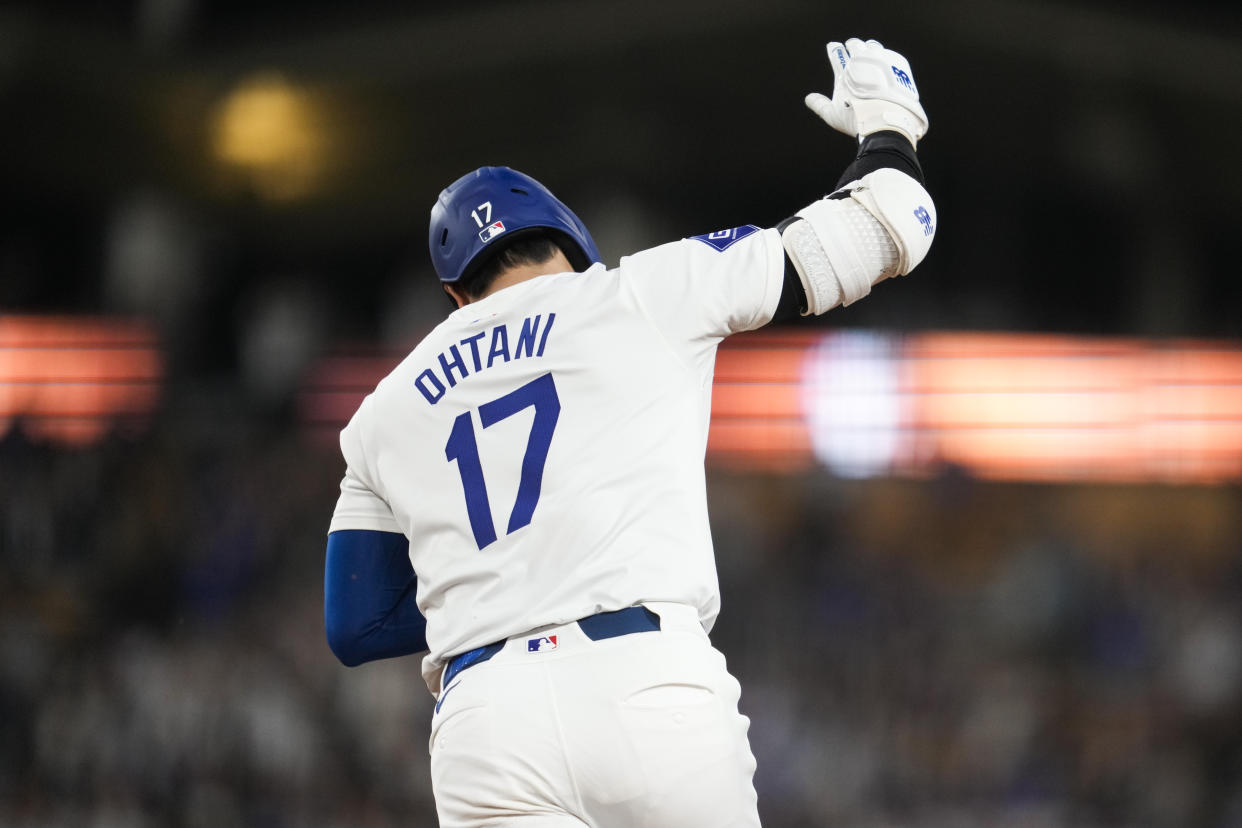 Los Angeles Dodgers designated hitter Shohei Ohtani (17) reacts after hitting a home run during the sixth inning of a baseball game against the Cleveland Guardians in Los Angeles, Friday, Sept. 6, 2024. (AP Photo/Ashley Landis)