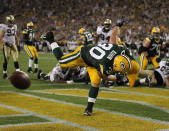 GREEN BAY, WI - SEPTEMBER 08: John Kuhn #30 of the Green Bay Packers spikes the ball after scoring a touchdown against the New Orleans Saints during the NFL opening season game at Lambeau Field on September 8, 2011 in Green Bay, Wisconsin. (Photo by Jonathan Daniel/Getty Images)