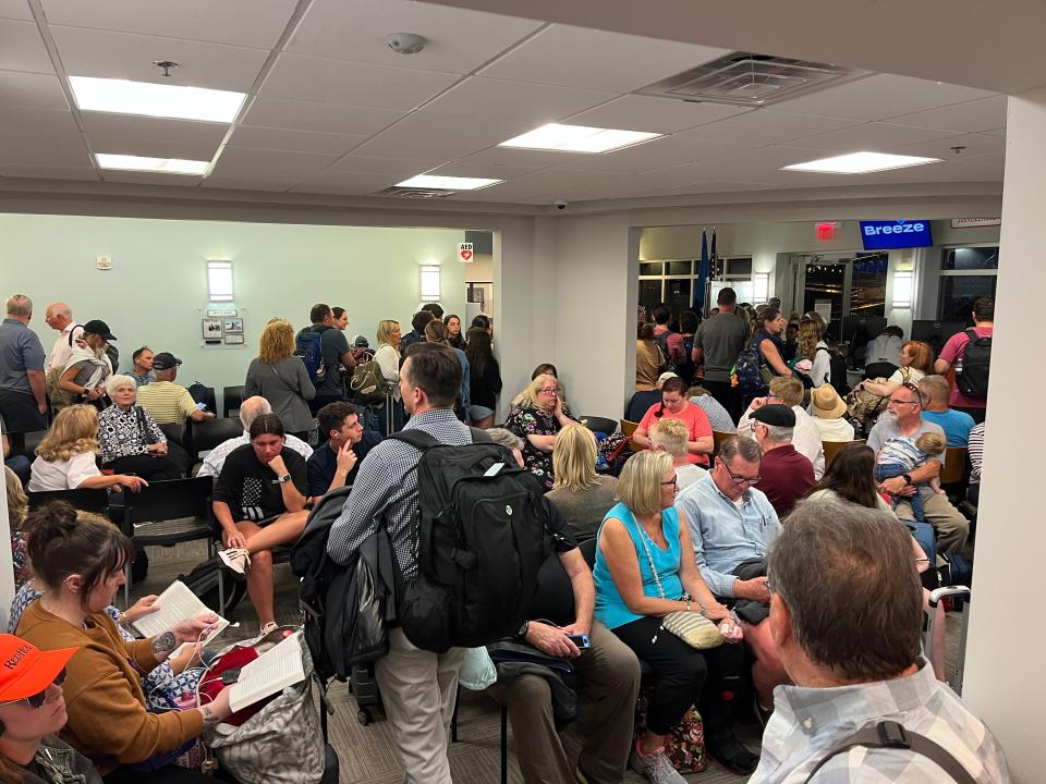 Passengers wait in the Vero Beach Municipal Airport terminal before boarding a Breeze Airways plane on March 18, 2023.