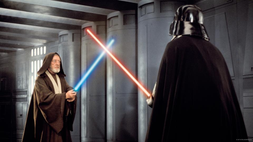 Alec Guiness, left, as Obi Wan Kenobi battles with Darth Vader in a scene from “Star Wars: A New Hope.”