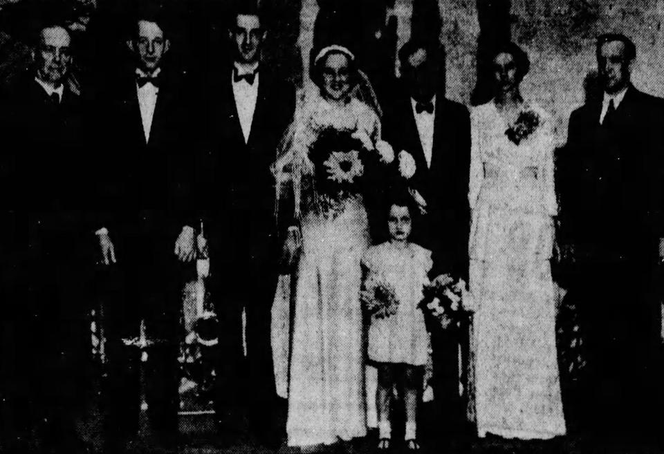 Flower girl Charlene Brasaemle stands next to bride Lillian Grell at a 1936 wedding in the Akron Armory. Also pictured, from left, are the Rev. Hugh Galloway, best man John Grell, groom Francis Grell, the bride's father Floyd McKnight, bridesmaid Maud McKnight and food show official S.J. Burnett.