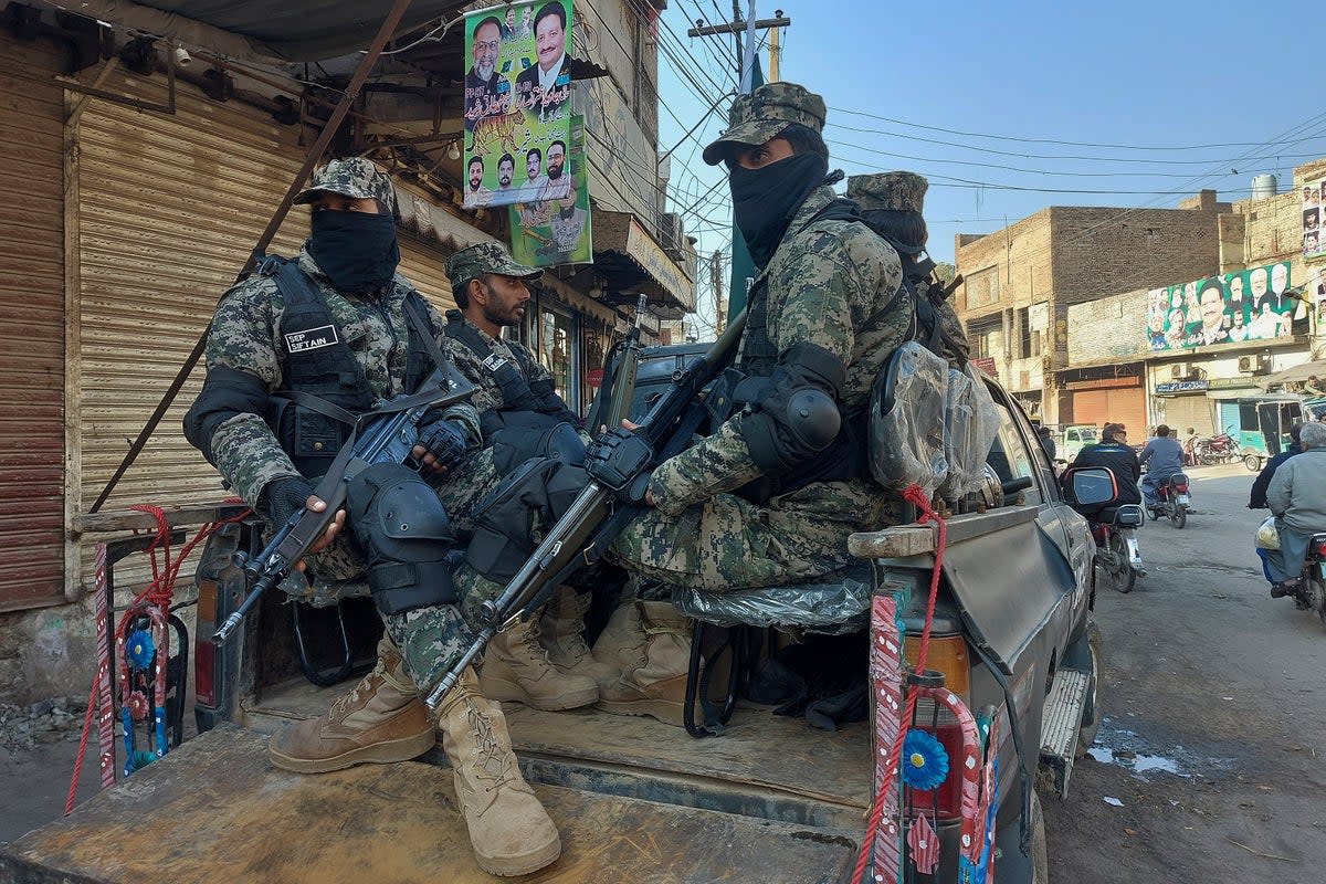 Paramilitary soldiers guard outside a polling station to ensure security during the country's parliamentary elections in Multan (AP)