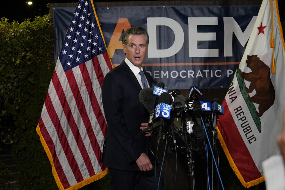 California Gov. Gavin Newsom walks to the podium to talk with reporters, after beating back the recall attempt that aimed to remove him from office, at the John L. Burton California Democratic Party headquarters in Sacramento, Calif., Tuesday, Sept. 14, 2021. (AP Photo/Rich Pedroncelli)