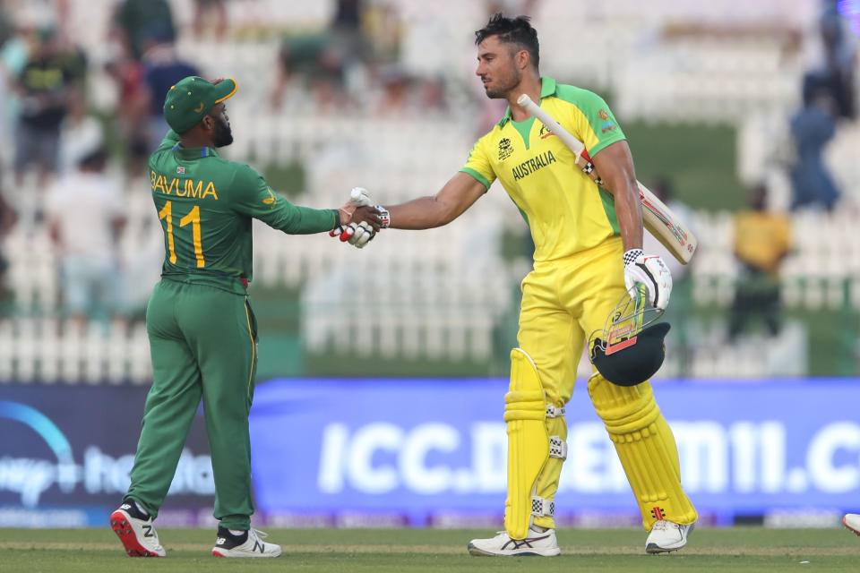 Australia's Marcus Stoinis, right, shakes hands with South Africa's Temba Bavuma following their Cricket Twenty20 World Cup match between South Africa and Australia in Abu Dhabi, UAE, Saturday, Oct. 23, 2021. (AP Photo/Kamran Jebreili)