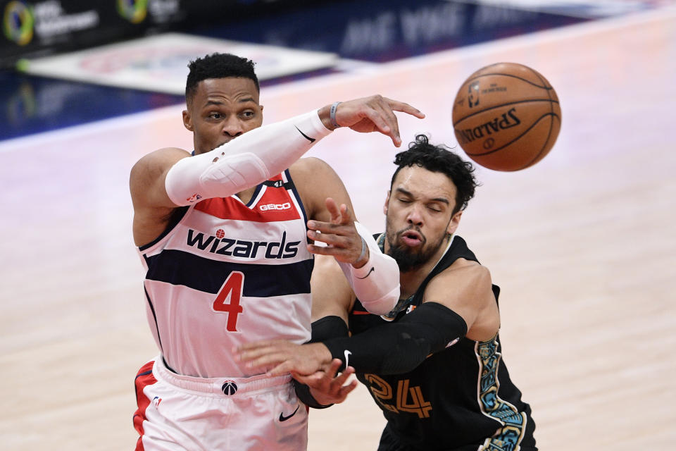 Washington Wizards guard Russell Westbrook (4) passes the ball against Memphis Grizzlies guard Dillon Brooks (24) during the second half of an NBA basketball game, Tuesday, March 2, 2021, in Washington. (AP Photo/Nick Wass)