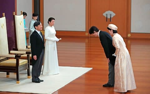 Emperor Naruhito and Empress Masako are greeted by Prince Akishino and Crown Princess Kiko  - Credit: Japan Pool via AP