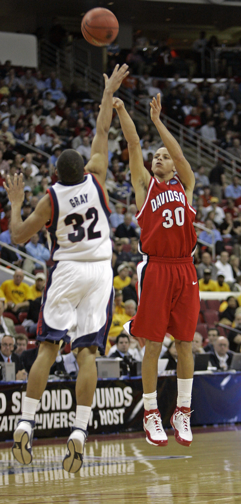 FILE - Davidson's Stephen Curry (30) attempts a three point shot over the defense of Gonzaga's Steven Gray (32) during the second half of a first round NCAA Midwest Regional basketball game in Raleigh, N.C., Friday, March 21, 2008. At Davidson, Curry led the Wildcats on one of the most memorable runs through the NCAA Tournament in 2008. Curry got it started by scoring 30 of his 40 points in the second half of a comeback win over Gonzaga, hitting 8 of 10 from 3-point range. (AP Photo/Chuck Burton, File)