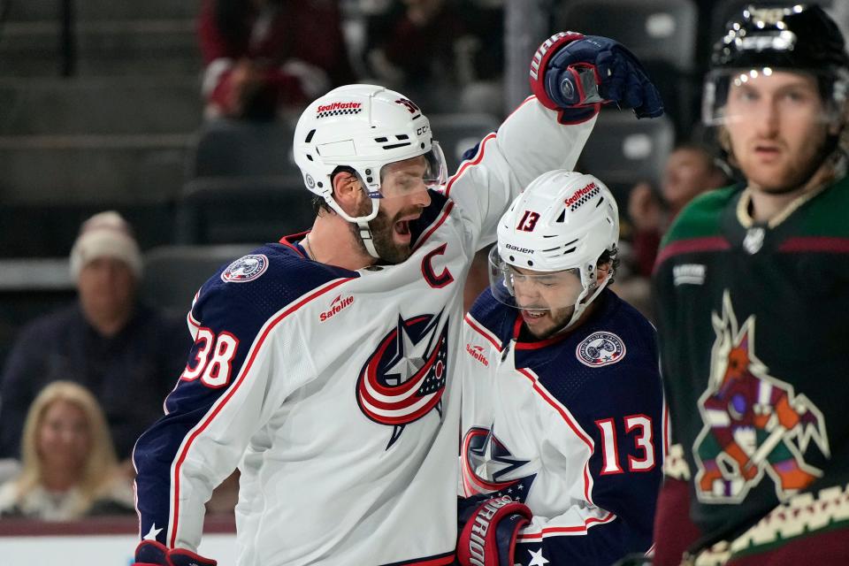 Mar 26, 2024; Tempe, Arizona, USA; Columbus Blue Jackets center Boone Jenner (38) celebrates with left wing Johnny Gaudreau (13) after scoring a goal against the Arizona Coyotes in the first period at Mullett Arena. Mandatory Credit: Rick Scuteri-USA TODAY Sports