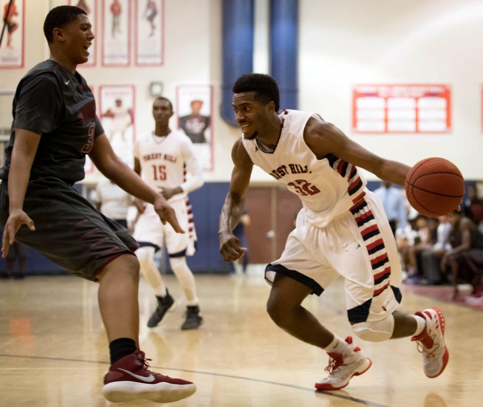 Forest Hill Falcons Phillip Lyttle (32) (right) drives the lane past Palm Beach Lakes Rams Giancarlo Rosado (34) in West Palm Beach, Florida on January 9, 2018.