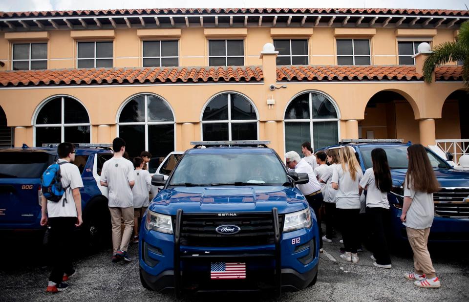 Participants in Palm Beach Crime Watch's Teen Academy check out a police vehicle on June 16. Crime Watch will hold its Spring Speaker Breakfast on April 16.