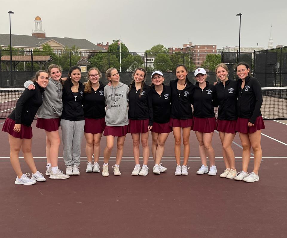 Members of the Portsmouth High School girls tennis team celebrate after Wednesday's 8-1 win in the opening round of the Division II state tournament.