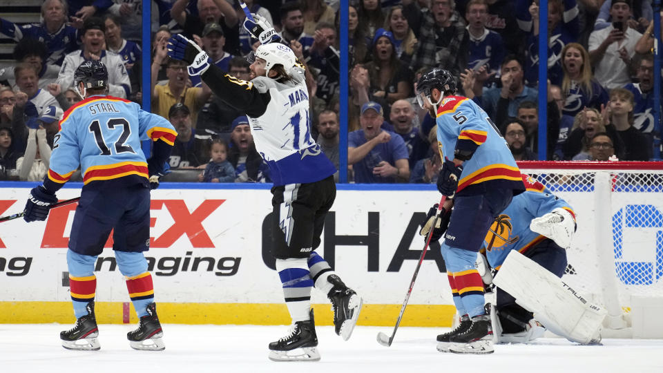 Tampa Bay Lightning left wing Pat Maroon (14) celebrates after scoring past Florida Panthers center Eric Staal (12), defenseman Aaron Ekblad (5) and goaltender Sergei Bobrovsky (72) during the first period of an NHL hockey game Saturday, Dec. 10, 2022, in Tampa, Fla. (AP Photo/Chris O'Meara)