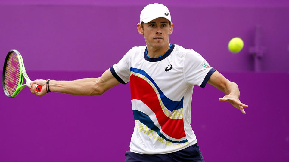 Seen here, Alex de Minaur returns a shot against Matteo Berrettini in the final at Queen's. 