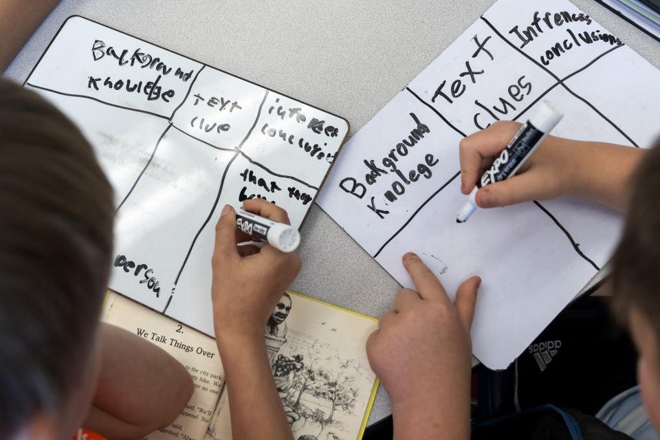 Students work on a writing assignment during a third grade English language arts class at Mount Vernon Community School, in Alexandria, Va., Wednesday, May 1, 2024. (AP Photo/Jacquelyn Martin)