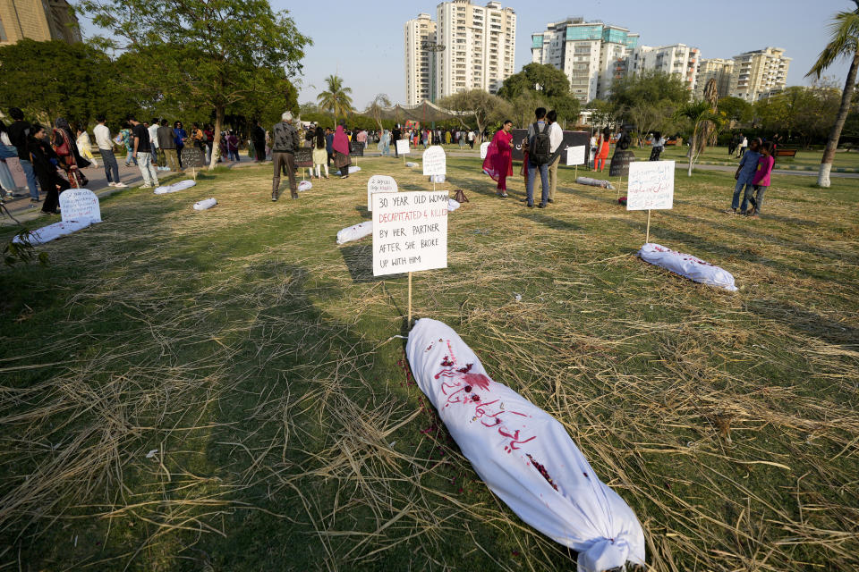 Activists from a socialist-feminist organization display mock bodies of the women victims of honor killings and domestic violence during a rally to mark International Women's Day, in Karachi, Pakistan, Friday, March 8, 2024. The day officially recognized by the United Nations in 1977, is celebrated around the world on March 8. (AP Photo/Fareed Khan)