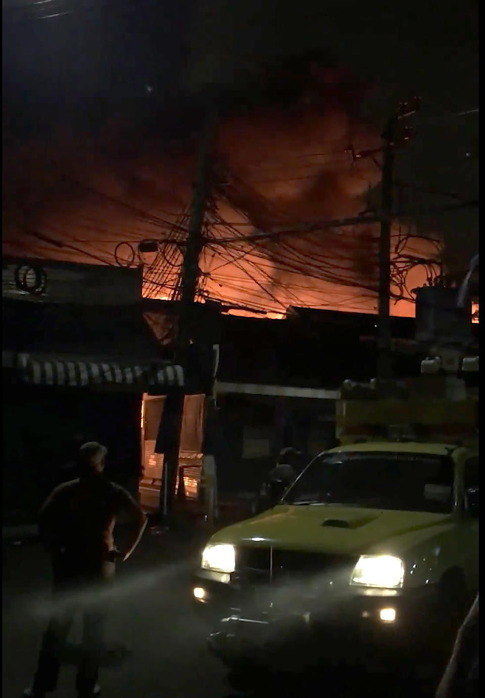 This Sunday, June 2, 2019 image taken from video provided by Younes Parvin shows a fire at Bangkok's Chatuchak weekend market, Thailand. Thai authorities are investigating an after-hours fire that roared through Chatuchak market, destroying dozens of the small shops crammed inside one of Asia's most popular bazaars. (Younes Parvin via AP Photo)