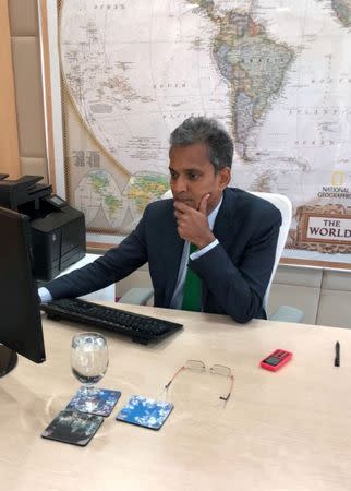 FILE PHOTO: Paddy Padmanathan, CEO of Acwa Power, uses a computer in his office in Riyadh, Saudi Arabia, February 11, 2018. REUTERS/Reem Shamseddine /File Photo