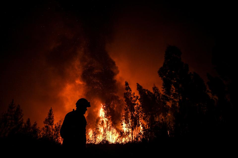 A firefighter passes while a wildfire burns the forest at Amendoa in Macao, central Portugal on July 21, 2019. (Photo: Patricia De Melo Moreira/AFP/Getty Images)