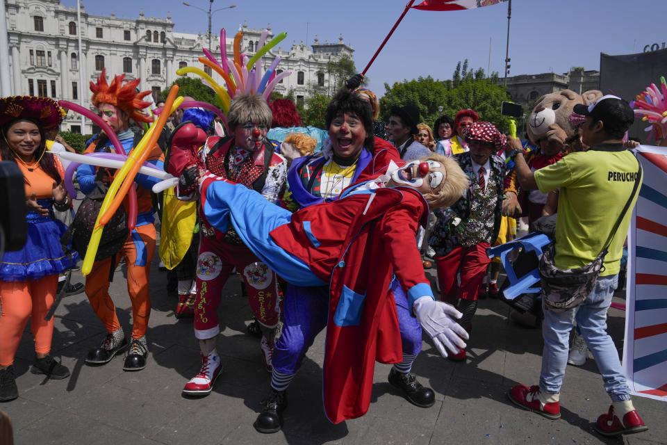 Clowns gather in the San Martin plaza to celebrate The Day of the Peruvian Clown, in Lima, Peru, Saturday, May 25, 2024. Professional clowns gather annually on this date to honor the beloved clown "Tony Perejil" who died on May 25, 1987 and was known as "the clown of the poor" because he performed in low-income neighborhoods to which he would donate a portion of his earnings. (AP Photo/Martin Mejia)