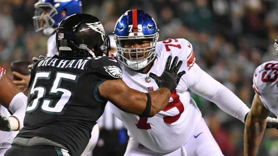 Jan 8, 2023; Philadelphia, Pennsylvania, USA; New York Giants guard Tyre Phillips (79) blocks against Philadelphia Eagles defensive end Brandon Graham (55) at Lincoln Financial Field.