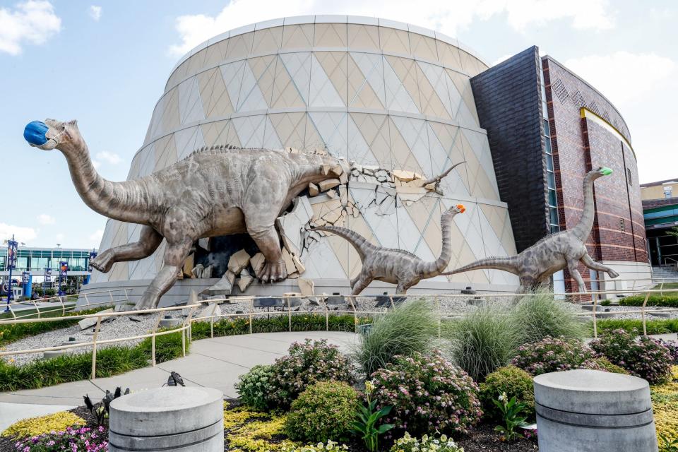 Dinos wear masks during the COVID-19 pandemic at the Children's Museum of Indianapolis.