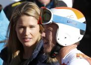 Bode Miller (R) of the U.S. stands next to his wife Morgan Beck after finishing the downhill run of the men's alpine skiing super combined event during the 2014 Sochi Winter Olympics at the Rosa Khutor Alpine Center in Rosa Khutor February 14, 2014. REUTERS/Leonhard Foeger