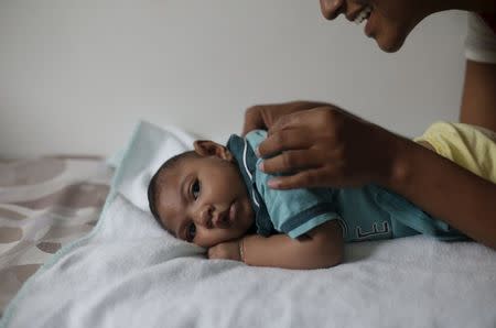 Mariam Araujo, 25, plays with Lucas, her 4-months old second child and born with microcephaly as they wait for a physiotherapy session in Pedro I hospital in Campina Grande, Brazil, February 17, 2016. REUTERS/Ricardo Moraes