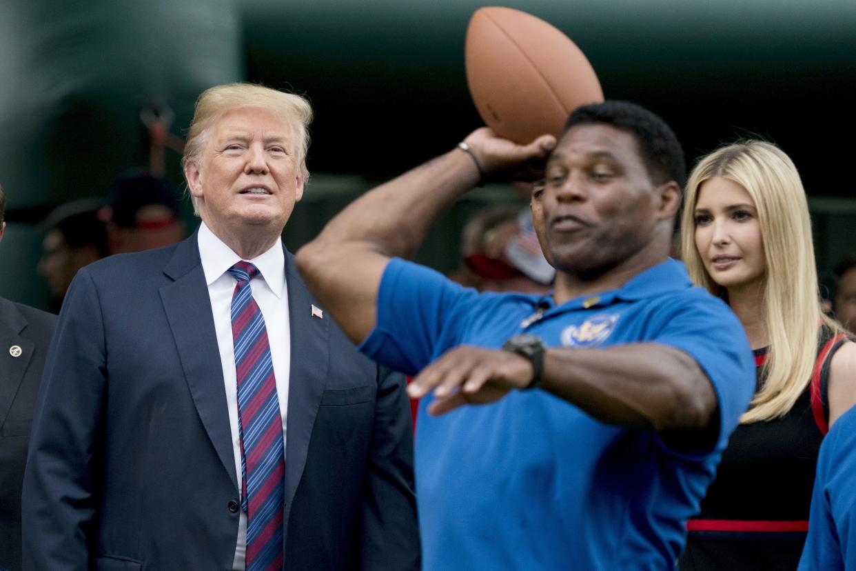 Then-President Donald Trump (left) Herschel Walker (center) and Ivanka Trump (right)