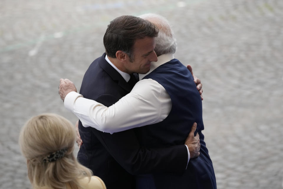 French President Emmanuel Macron, left, meets Indian Prime Minister Narendra Modi during the Bastille Day parade on the Champs-Elysees avenue in Paris, Friday, July 14, 2023. (AP Photo/Christophe Ena)