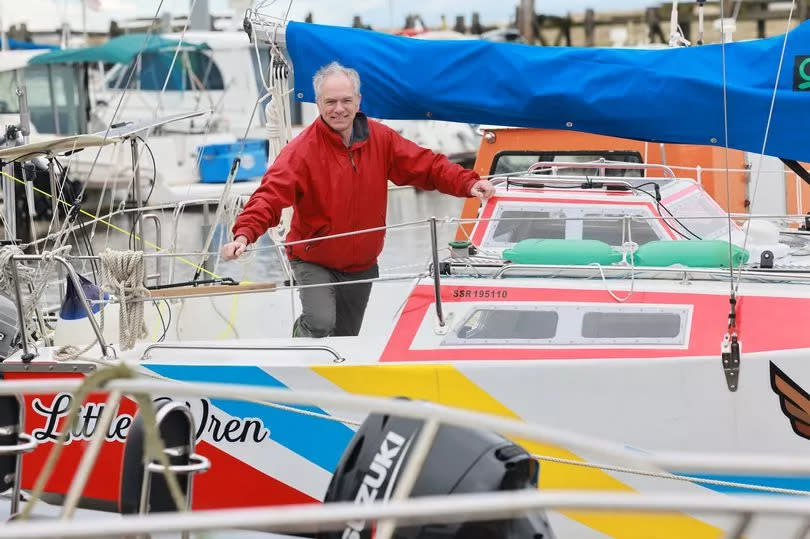 Adam Waugh on his boat 'Little Wren', which he built from scratch, at Amble Marina in Northumberland