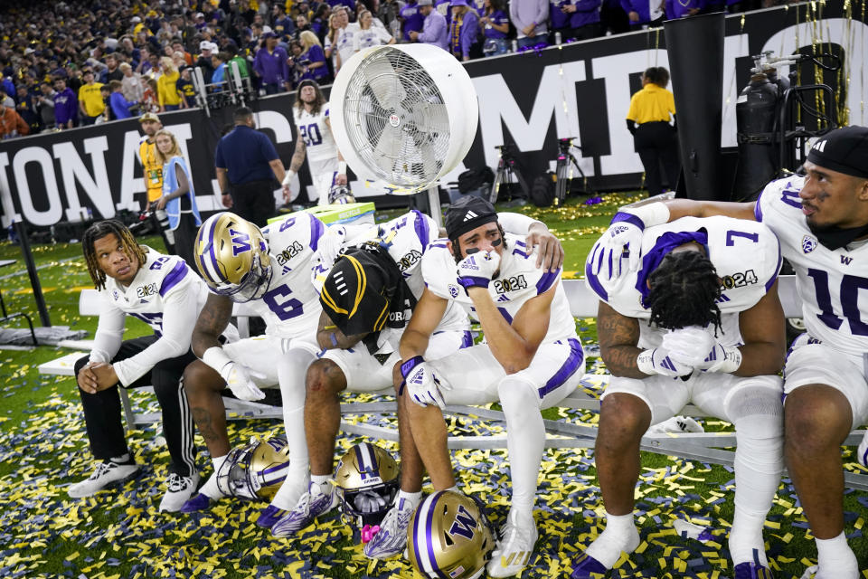 Members of the Washington team react to their loss against Michigan in the national championship NCAA College Football Playoff game Monday, Jan. 8, 2024, in Houston. (AP Photo/Eric Gay)