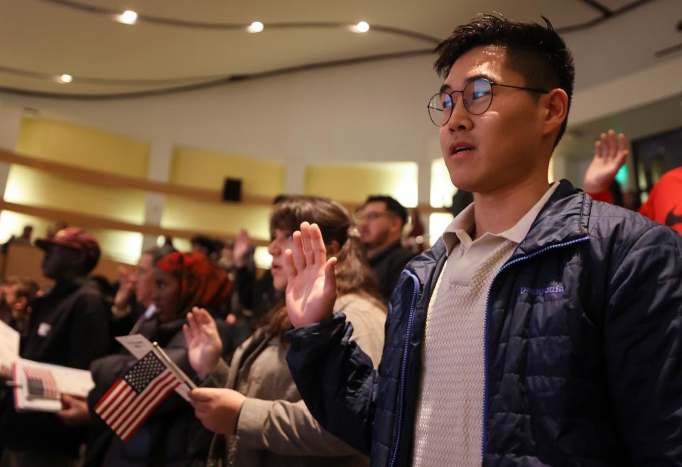 New citizens take the naturalization oath of allegiance to the United States of America during a naturalization ceremony at the Salt Lake City Public Library in Salt Lake City on Wednesday, Feb. 14, 2024. | Kristin Murphy, Deseret News