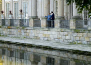 German Chancellor Angela Merkel, left, stands on a balcony as she meets Poland's Prime Minister Mateusz Morawiecki in Warsaw, Poland, Saturday, Sept.11, 2021.Merkel is visiting the Polish capital Morawiecki at a time when Poland faces migration pressure on its eastern border with Belarus. (AP Photo/Czarek Sokolowski)