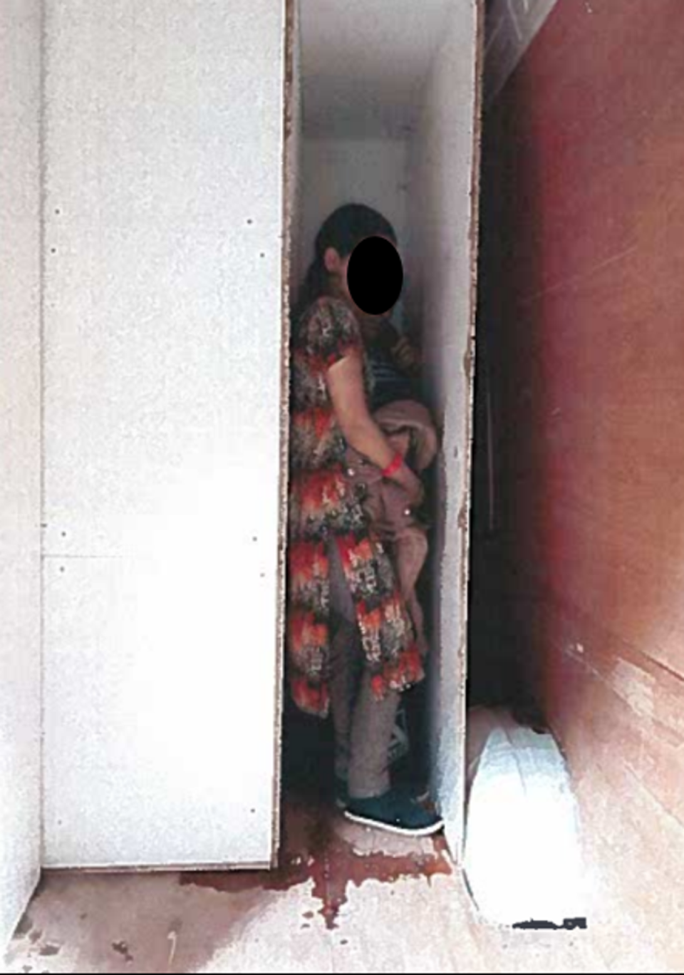 A woman and child in a coffin-like hide (Home Office)