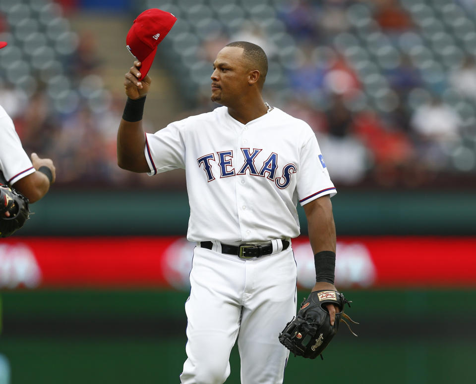 Texas Rangers' Adrian Beltre tips his cap to the Seattle Mariners bench after being relieved at third base during the sixth inning of a baseball game, Sunday, Sept. 23, 2018, in Arlington, Texas. (AP Photo/Jim Cowsert)