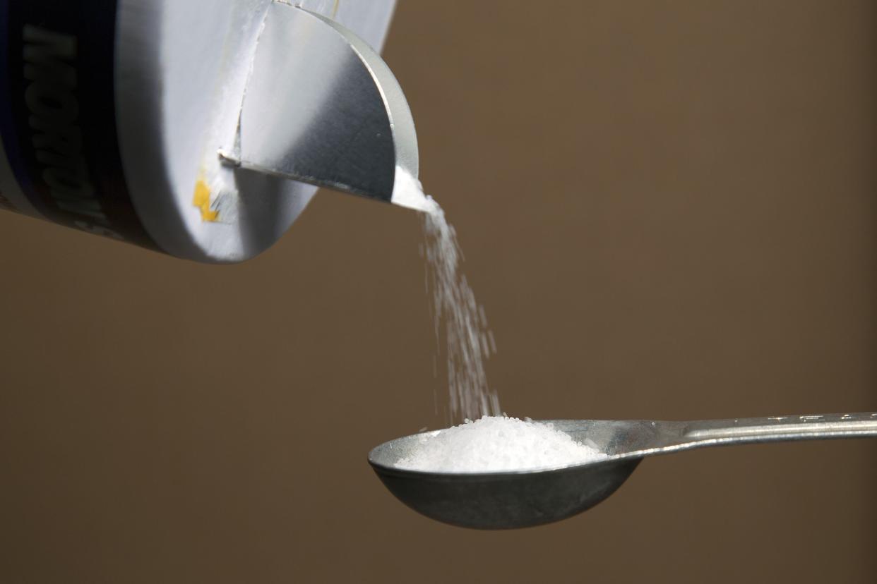 pouring salt onto spoon