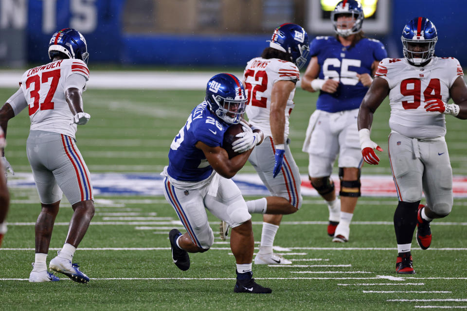 New York Giants running back Saquon Barkley (26) rushes during a scrimmage at the NFL football team's training camp in East Rutherford, N.J., Friday, Aug. 28, 2020. (AP Photo/Adam Hunger)