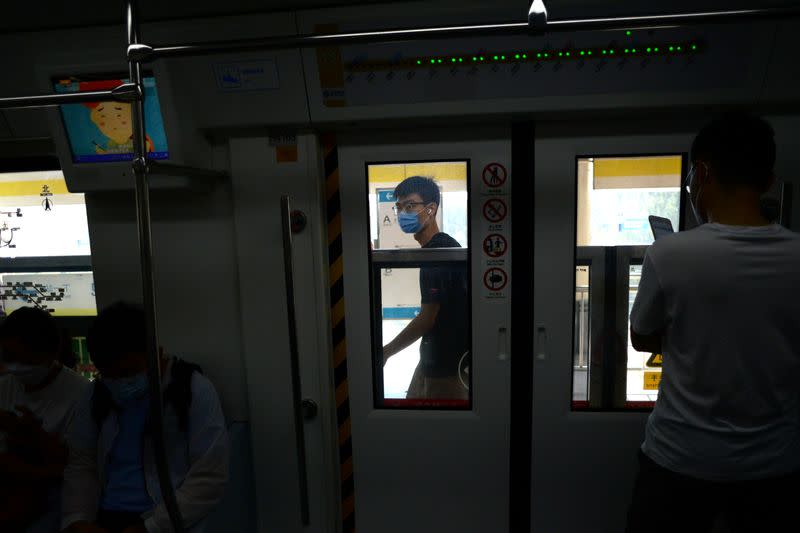 People wearing face masks commute inside a subway station during morning rush hour, following an outbreak of the novel coronavirus disease (COVID-19), in Beijing