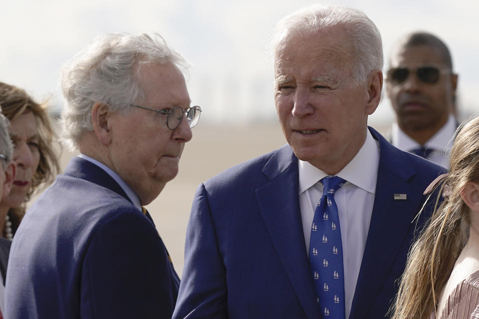 FILE - Senate Minority Leader Mitch McConnell of Ky., looks to President Joe Biden after Biden arrived at Cincinnati/Northern Kentucky International Airport in Hebron, Ky., Jan. 4, 2023. By temperament and manner, Joe Biden and Mitch McConnell are decidedly mismatched. But as the days of divided government under Biden begin, their long relationship will become even more vital. McConnell’s experience in cutting deals and the political capital he retains among his members could leave him much freer to negotiate thorny matters with the White House. (AP Photo/Patrick Semansky, File)