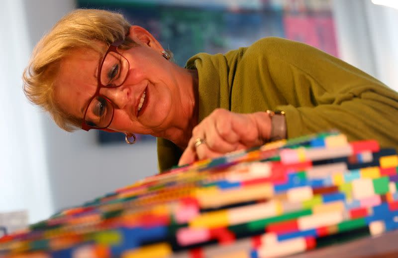 Rita Ebel, nicknamed "Lego grandma", builds a wheelchair ramp from donated Lego bricks in the living room of her flat in Hanau