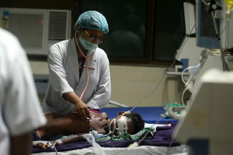 Medical staff attend to a child at the Gorakhpur hospital where parents blame many deaths on oxygen shortages